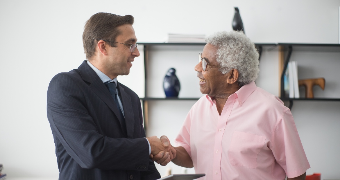 An Insurance Agent and an Elderly Man Shaking Hands