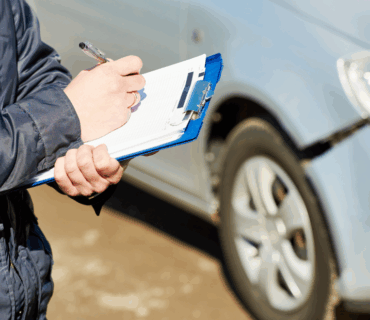 Insurance Agent Recording Car Damage