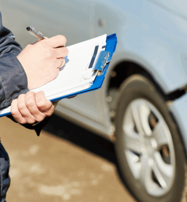 Insurance Agent Recording Car Damage