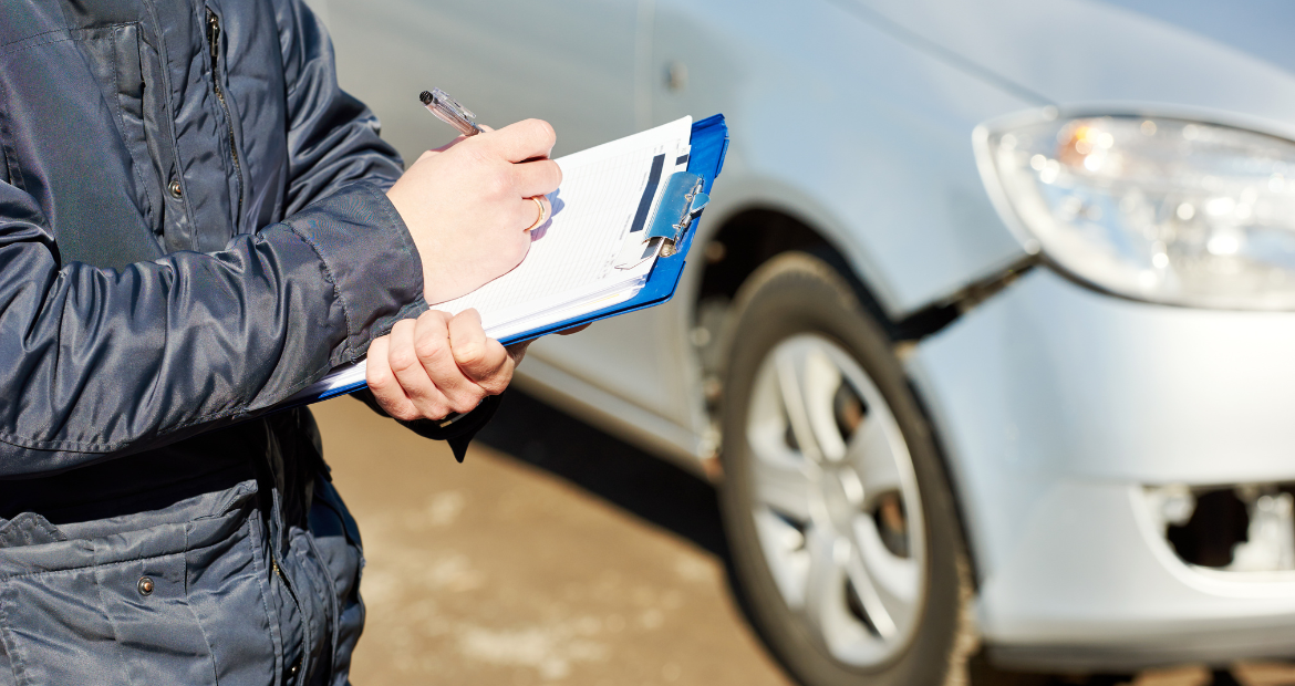 Insurance Agent Recording Car Damage